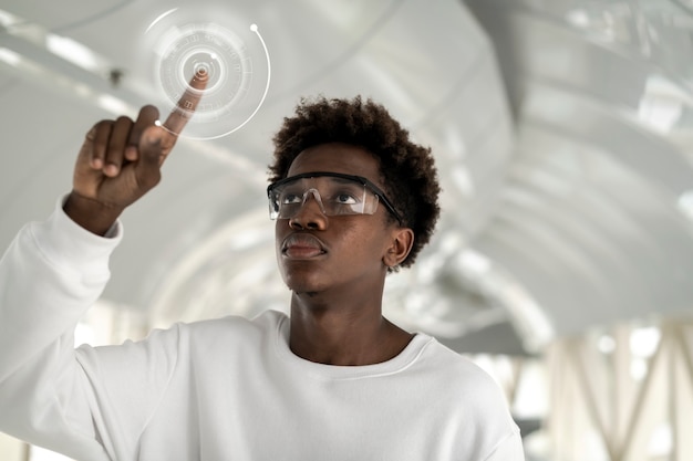 Man wearing smart glasses touching a holographic screen