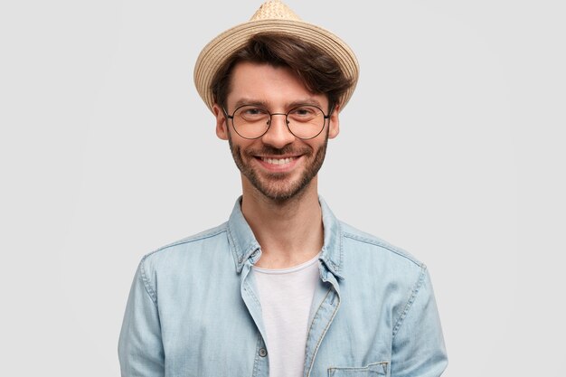 Man wearing straw hat and denim shirt