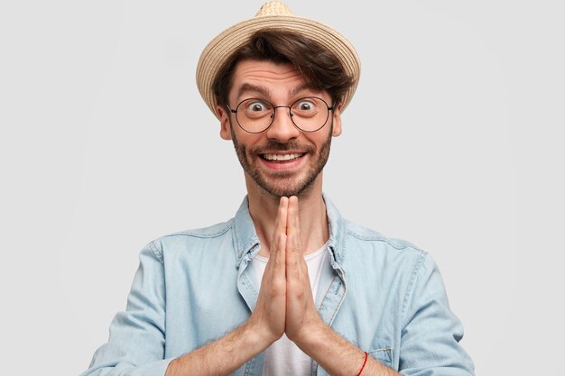 Man wearing straw hat and denim shirt