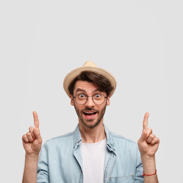 Man wearing straw hat and denim shirt