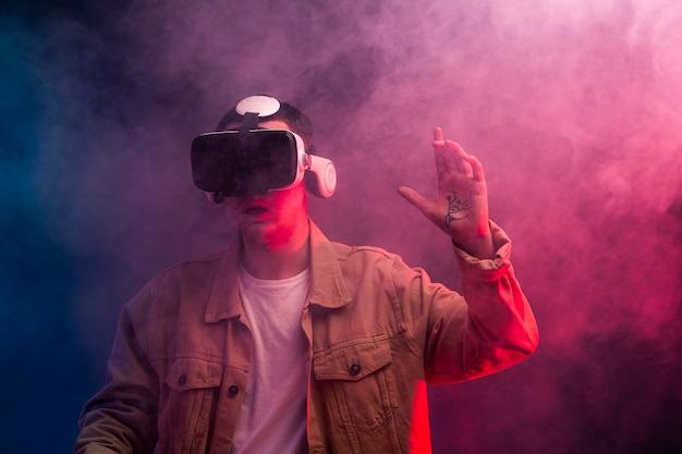 Free photo man wearing virtual reality goggles for video game