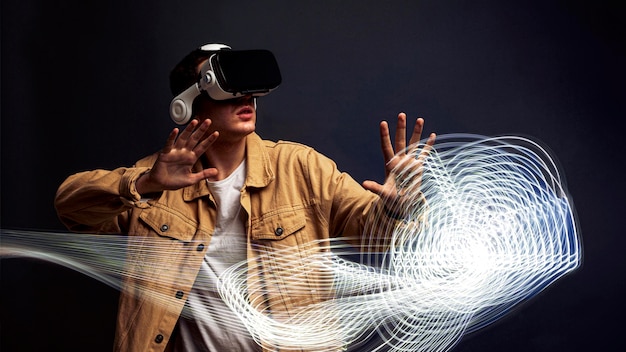 Foto gratuita uomo che indossa occhiali per realtà virtuale con effetti speciali intorno a lui