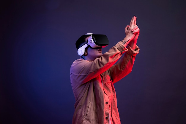 Free photo man wearing vr goggles for shooting game