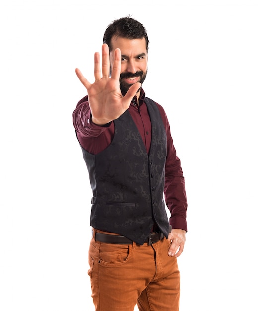 Man wearing waistcoat counting five