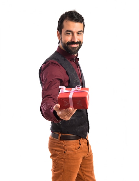 Man wearing waistcoat holding a gift