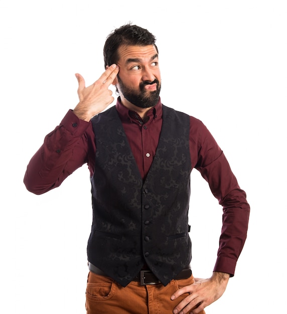 Man wearing waistcoat making suicide gesture