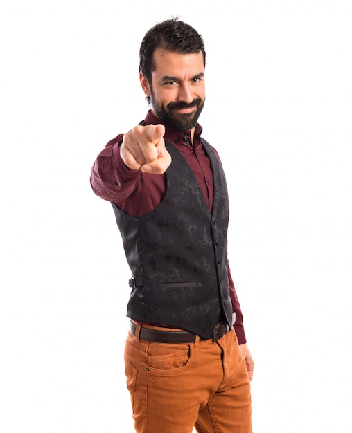 Free photo man wearing waistcoat pointing to the front
