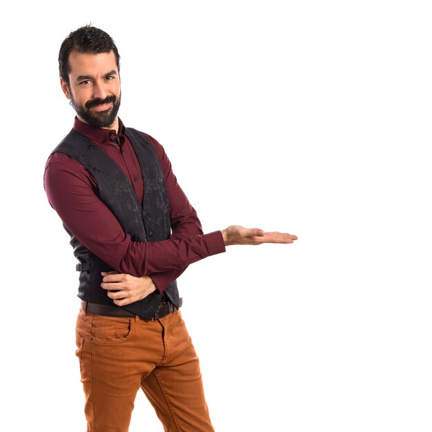 Man wearing waistcoat presenting something