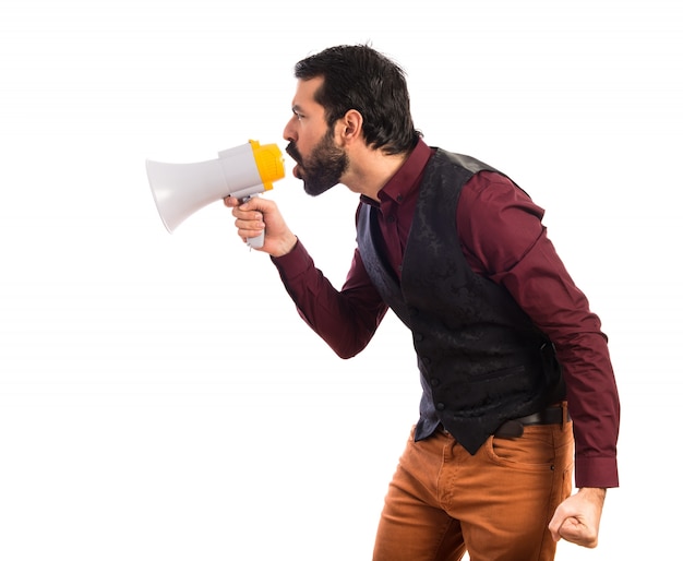 Man wearing waistcoat shouting by megaphone