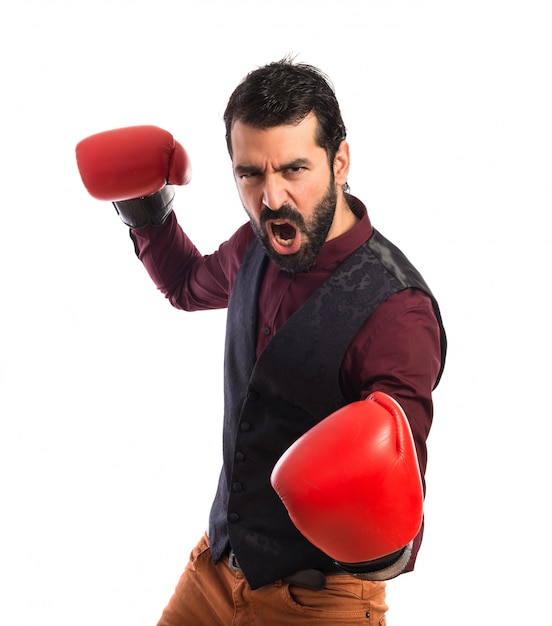 Man wearing waistcoat with boxing gloves