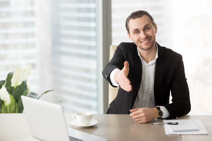 Free Photo man welcomes business partners on negotiations