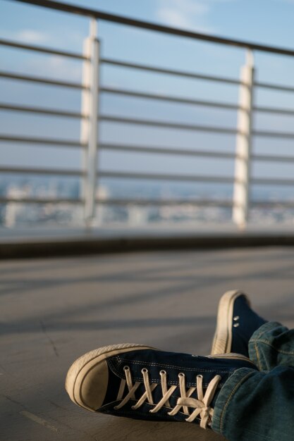 man were sneaker sit on top of building