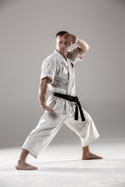 Man in white kimono training karate