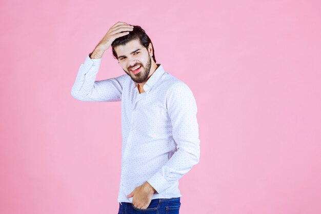 Man in a white shirt giving neutral and appealing poses.