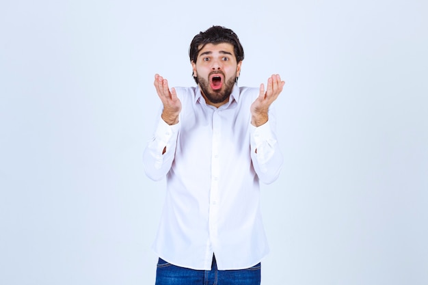 Man in a white shirt looks confused and lost