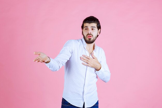 Man in a white shirt looks confused and lost.