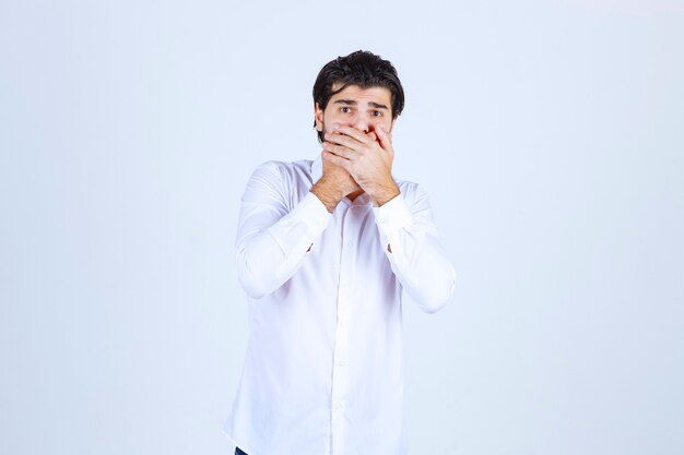 Man in a white shirt looks excited and thrilled