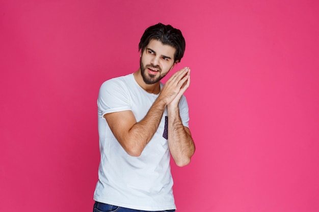 Man in white shirt looks exhausted and sleepy.