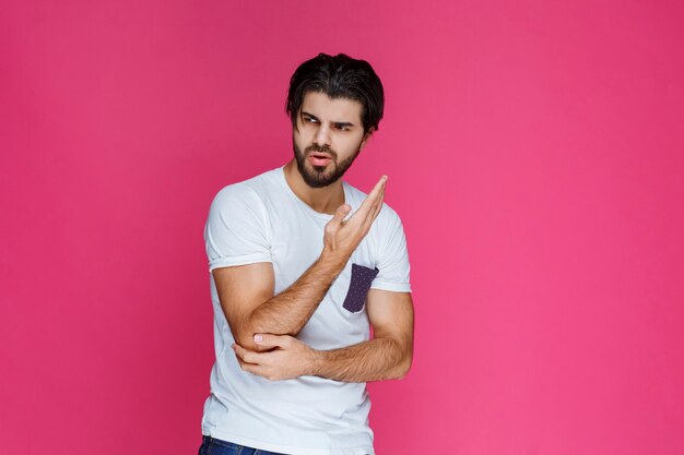 Man in white shirt pointing to something with his pointing finger.