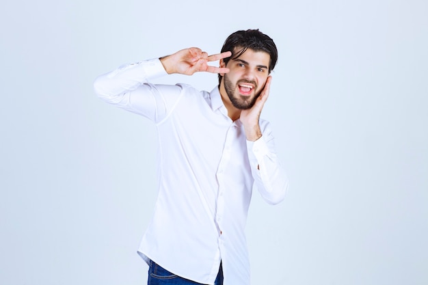 Man in a white shirt sending peace and friendship message