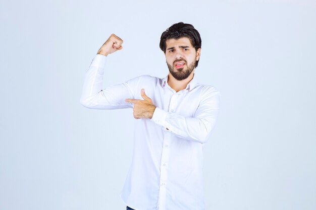 Man in white shirt showing his fists and feeling successful