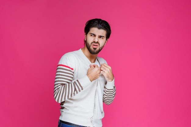 Man in white shirt showing his fists and power. 