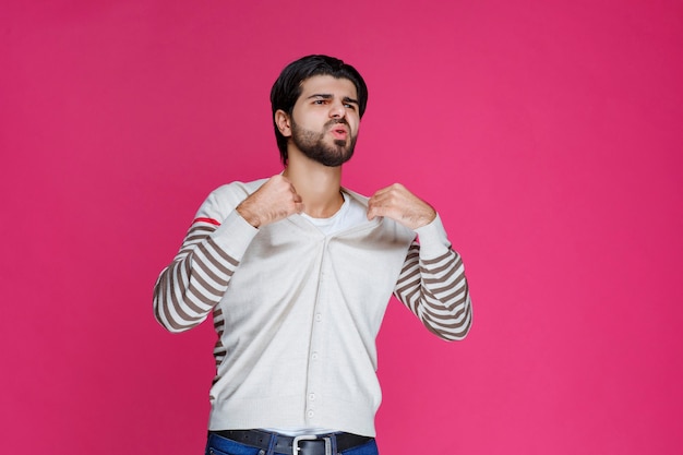 Man in white shirt showing his fists and power. 