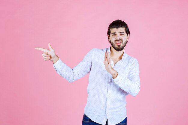 感情を込めて左側を見せている白いシャツを着た男。