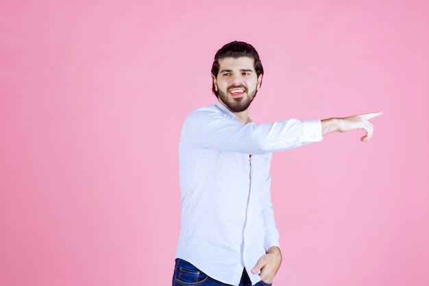 Man in a white shirt showing right side with emotions.