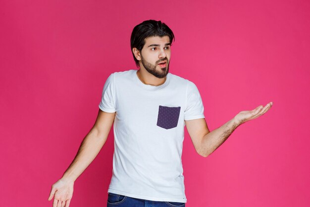 Man in white shirt showing that he has no idea about the topic. 