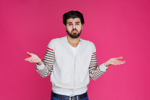 Man in white shirt showing that he has no idea about the topic. 