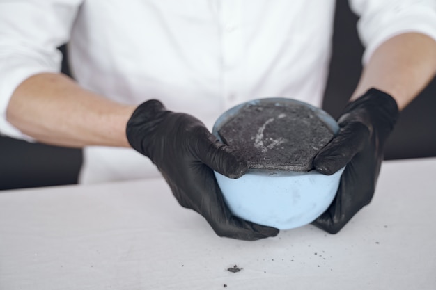 Free photo man in a white shirt works with a cement