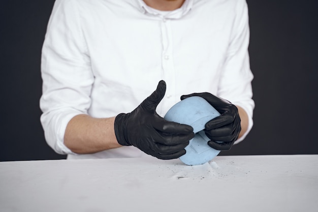 Man in a white shirt works with a cement