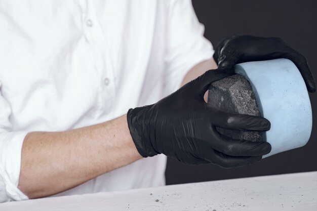 Man in a white shirt works with a cement