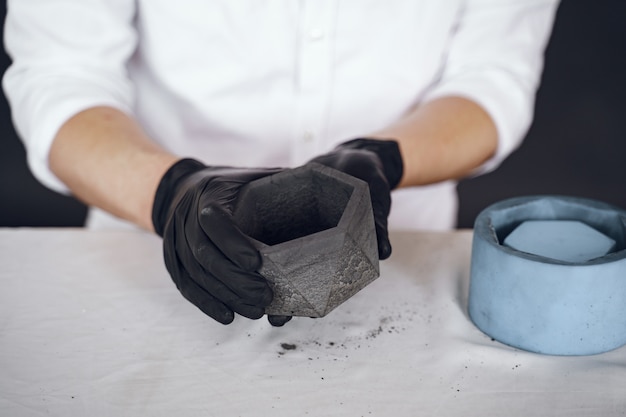 Free photo man in a white shirt works with a cement