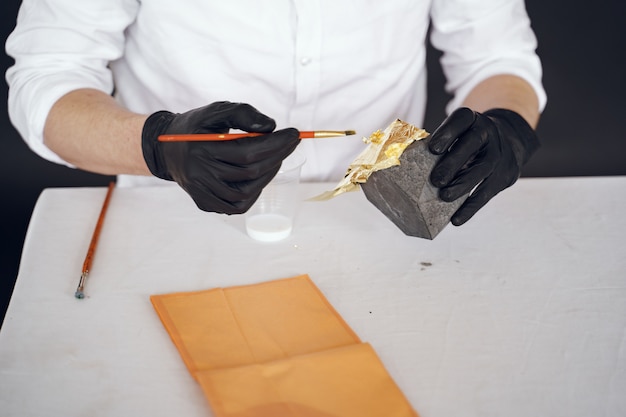 Free photo man in a white shirt works with a cement