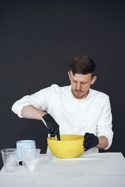 Man in a white shirt works with a cement