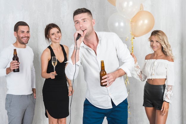 Free photo man in white singing on party