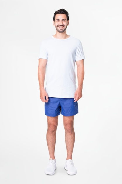 Man in white t-shirt and blue shorts with design space full body