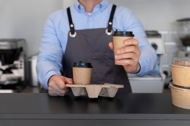 Man with apron preparing food for takeaway