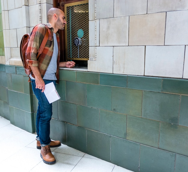 Free photo man with backpack checking city views