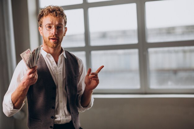 Man with banknotes isolated in studio