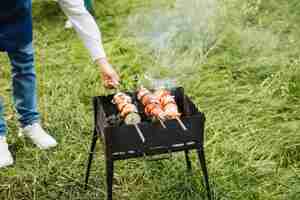 Free photo man with a barbecue in nature