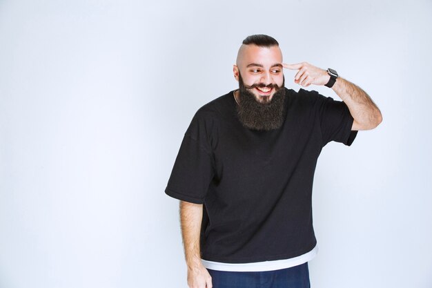 Man with beard demonstrating his arm muscles and fists.