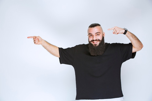 Man with beard demonstrating his arm muscles and fists.