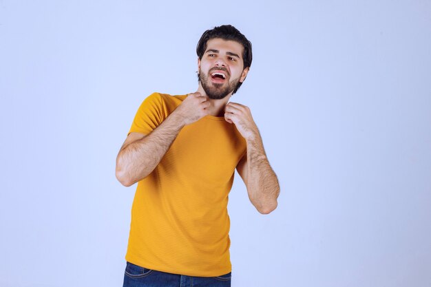 Man with beard demonstrating his fist and arm muscles and feeling powerful