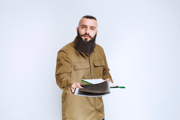 Man with beard giving his project list for verification. 