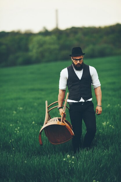 Man with a beard and glasses in the green field