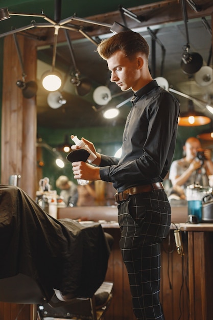 Man with a beard. Hairdresser with a client. Man with a brush.