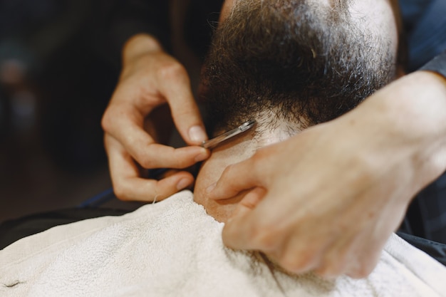 Man with a beard. hairdresser with a client. man with a shave. Free Photo
